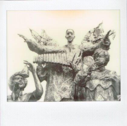 sepia of statuary of people playing instruments and singing