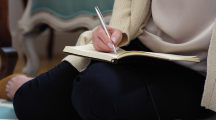 Woman writing in a journal