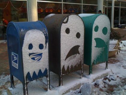 Snow faces on three mailboxes