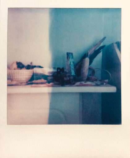 A collection of objects atop a fireplace mantel.