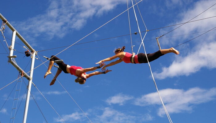 Trapeze artists in mid-flight