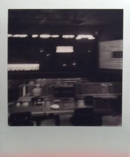 Blurry black and white image on an interior of some sort.