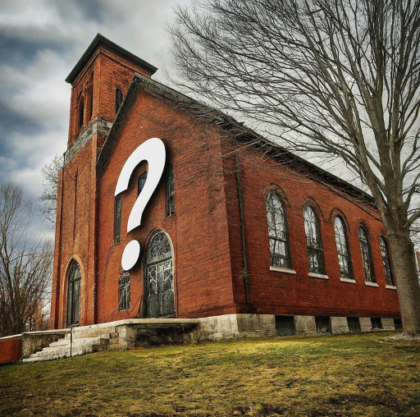 A red brick church with a white ? superimposed on it.