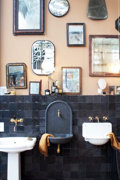 Collection of framed items in an old style bathroom