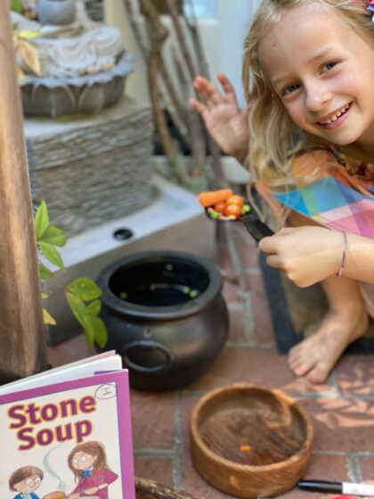 Child preparing stone soup.