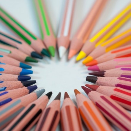 Colored pencils in forming a circle with the pointed ends facing in.