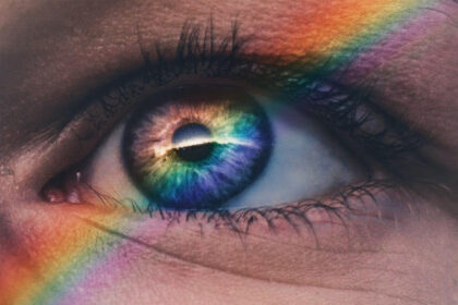 closeup of an eye with a rainbow running through it