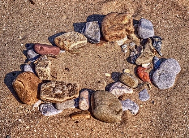 colorful polished rocks on a sandy beach